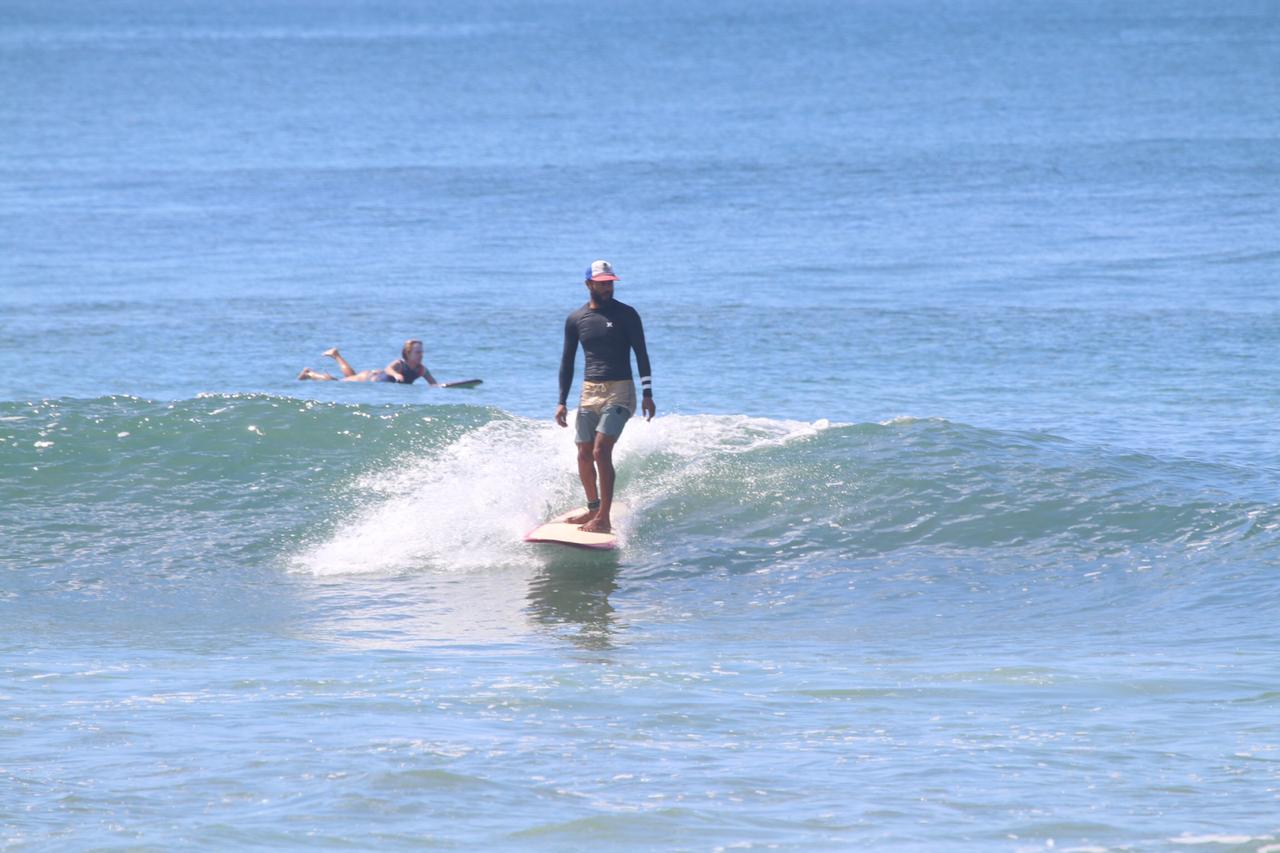 Eli longboarding a small clean wave